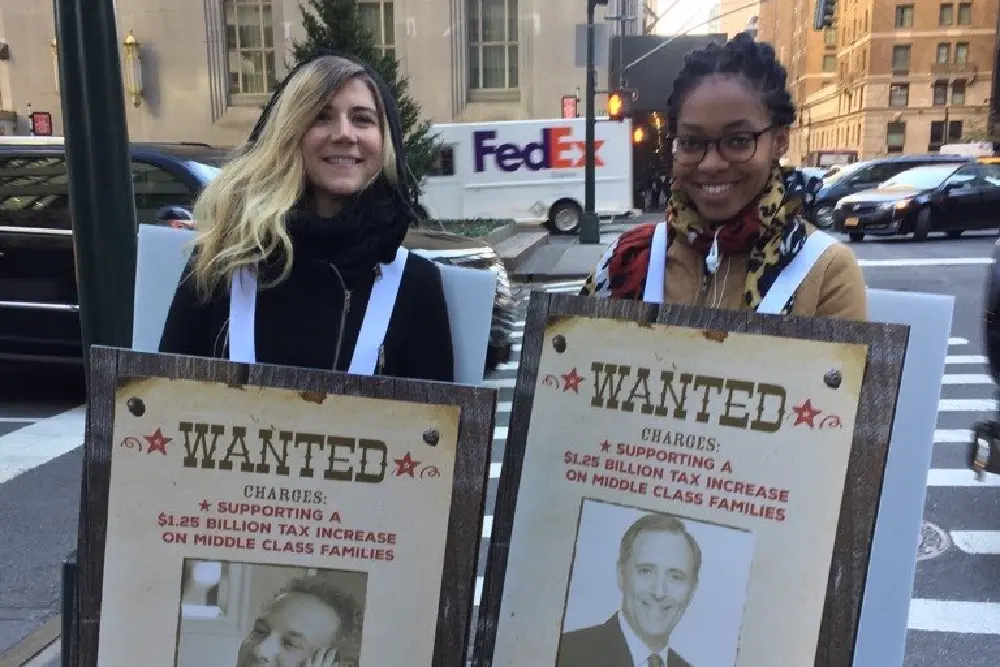 Unitist, community organizing. CALinnovates protesters holding signs
